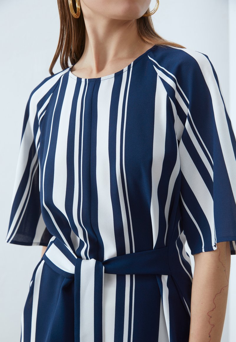 Alonic Women's Navy Blue and White Striped Peplum Top